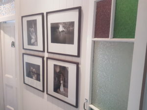 hallway featuring group of four picture frames