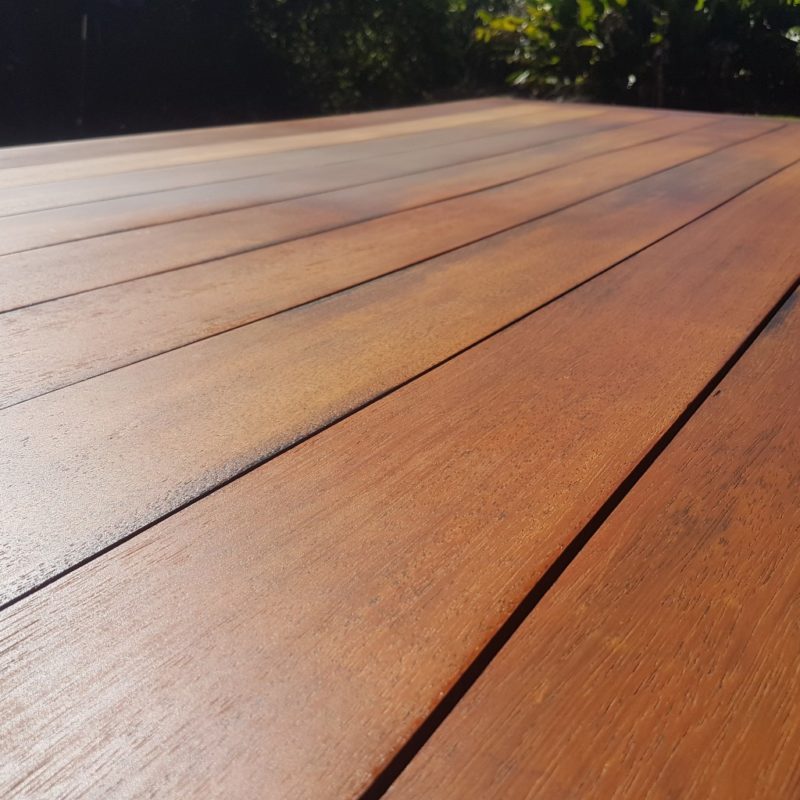 Expanse of timber that has been treated with oil to rejuvinate the surface on this outdoor table